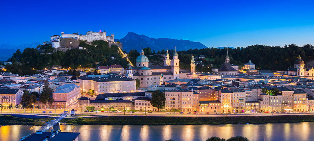 View of cityscape of Salzburg Cathedral, Fortress Hohensalzburg, and old castle in center of old town