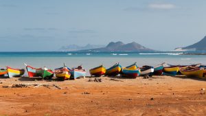 Fishing boats rest in Mindelo beach, Cape Verde.
