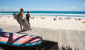 Surfers, walking and talking, Noosa, Queensland, Australia