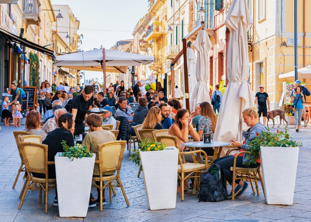  Tourists at street cafe on Corso Umberto Street in Olbia, Sardinia, Italy