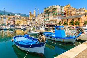 Traditional fishing boats in Bastia port on sunny summer day, Corsica island, France