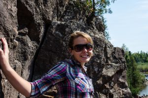 Smiling next to a rocky background in North Minnesota