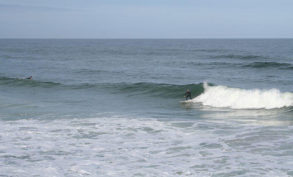 Surfers riding waves at Daytona Beach Florida