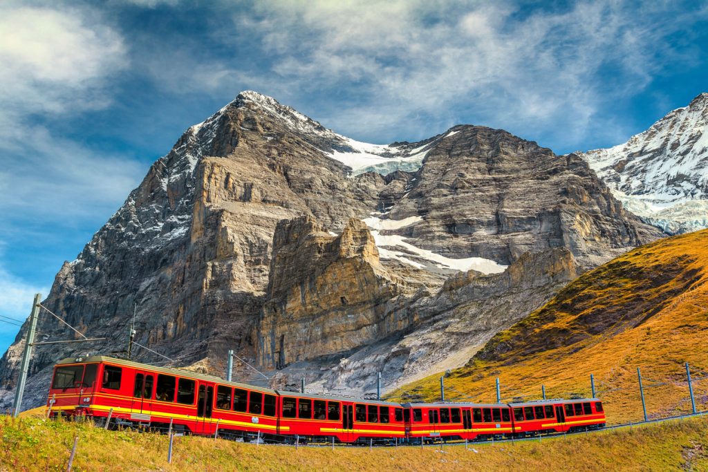 Famous express electric red tourist train coming down from the Jungfraujoch station (top of Europe) in Kleine Scheidegg tourist station, Bernese Oberland, Switzerland, Europe
