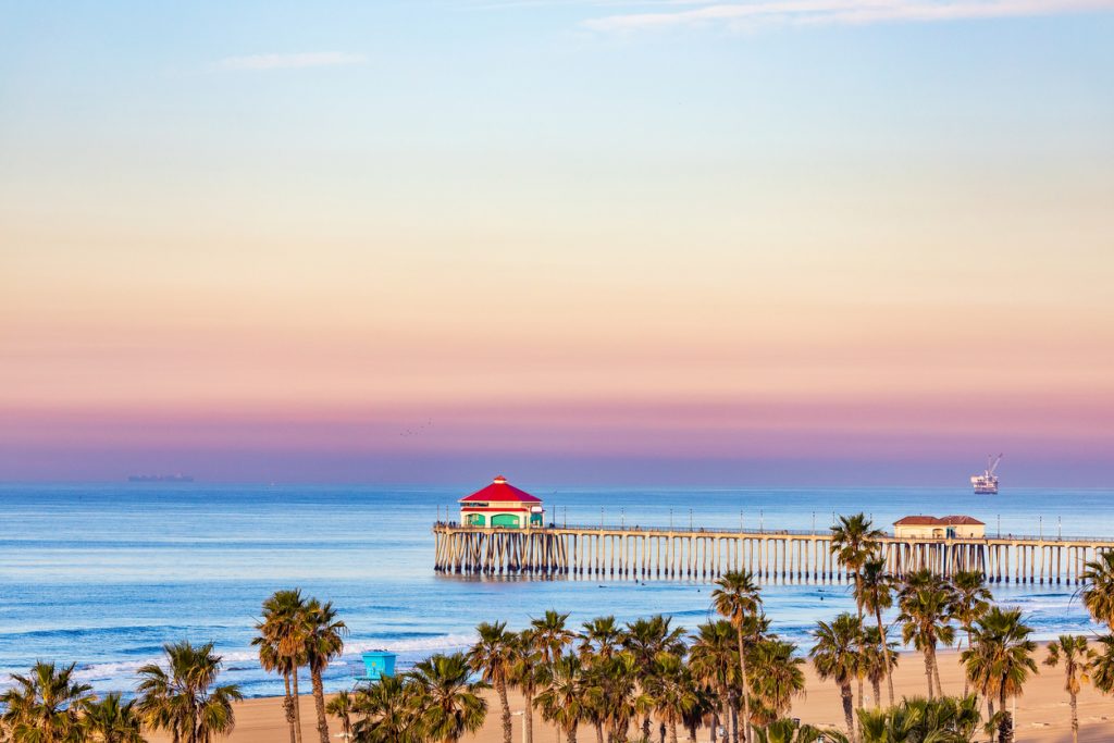 Sunrise sky over Huntington Beach Pier and the Pacific Ocean in Huntington Beach, California.