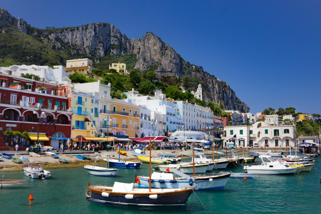 This is the island of Capri as you enter it from the main ferry from Sorrento, Italy. The view is stunning with all it's vibrant colors and tones.  This shot captures the feeling of the busy but calming nature of this tourist destination.