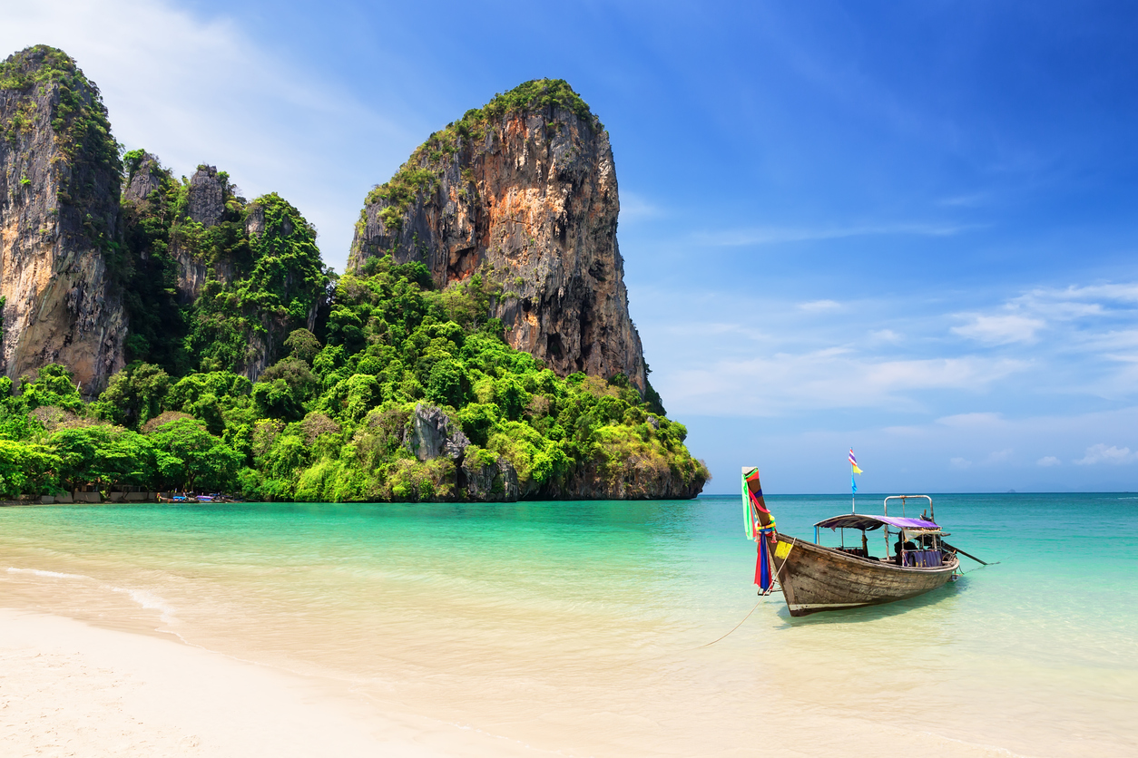 Thai traditional wooden longtail boat and the beautiful sandy beach