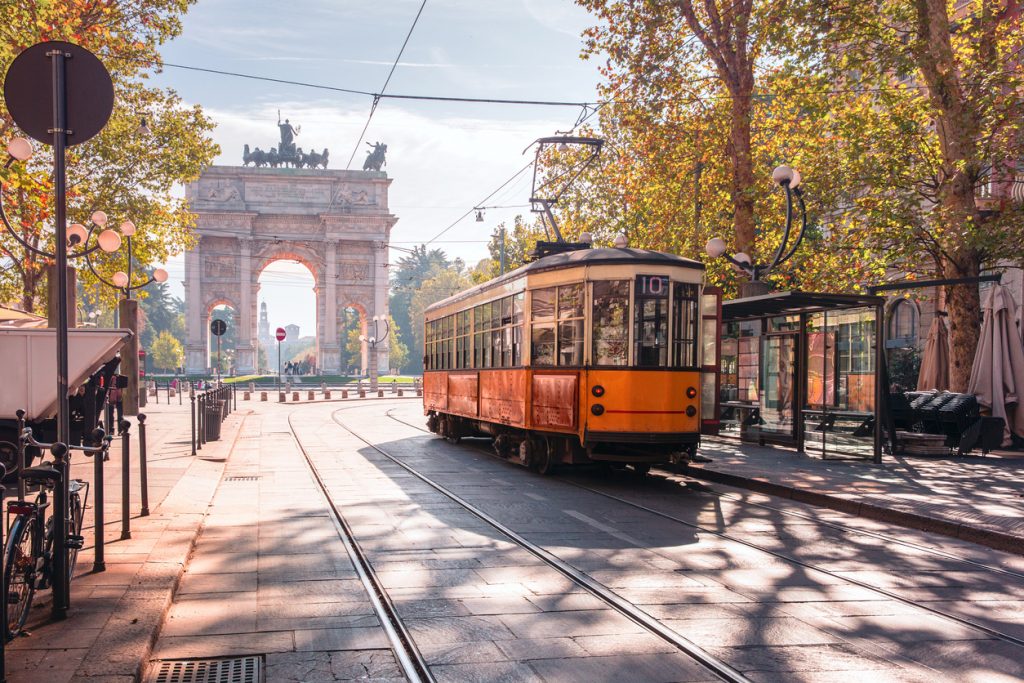 Famous vintage tram in the centre of the Old Town of Milan in the sunny day.