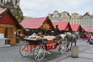 Prague, Christmas market on the old town square and traditional horse and coach