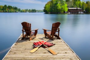 Muskoka chairs on a wooden dock