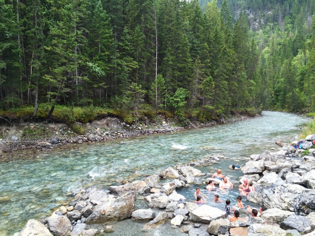 Bathers enjoy the riverside natural thermal waters of Lussier Hot Springs in southeastern B.C.