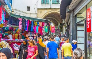 The crowded clothes bazaar stretches along the narrow Kasbah street in Medina