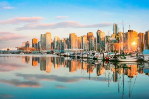 Beautiful view of Vancouver skyline with Stanley Park at sunset, British Columbia, Canada.