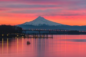 A vibrant pink sunrise over the Columbia River and Mt Hood, Portland Oregon