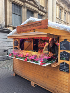 A vendor sells artisan bread of Jesus for Christmas and St. Nicholas Day at the Brussels Christmas market.