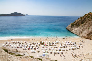 Tourists sunbathing and swimming on the Kaputas Beach, Kas, in Turkey