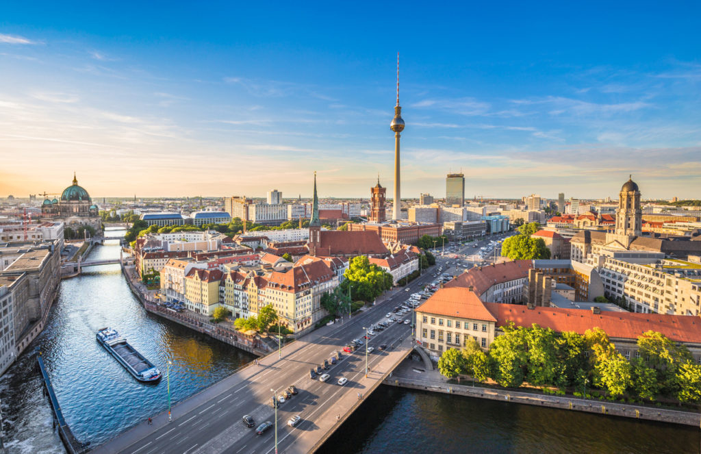 Aerial view of Berlin skyline with famous TV tower and Spree river in beautiful evening light at sunset, Germany.