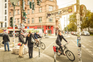 Everyday life in Berlin with bikers and pedestrians moving around