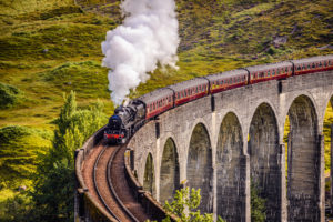 Glenfinnan Railway Viaduct in Scotland with the Jacobite steam train passing over