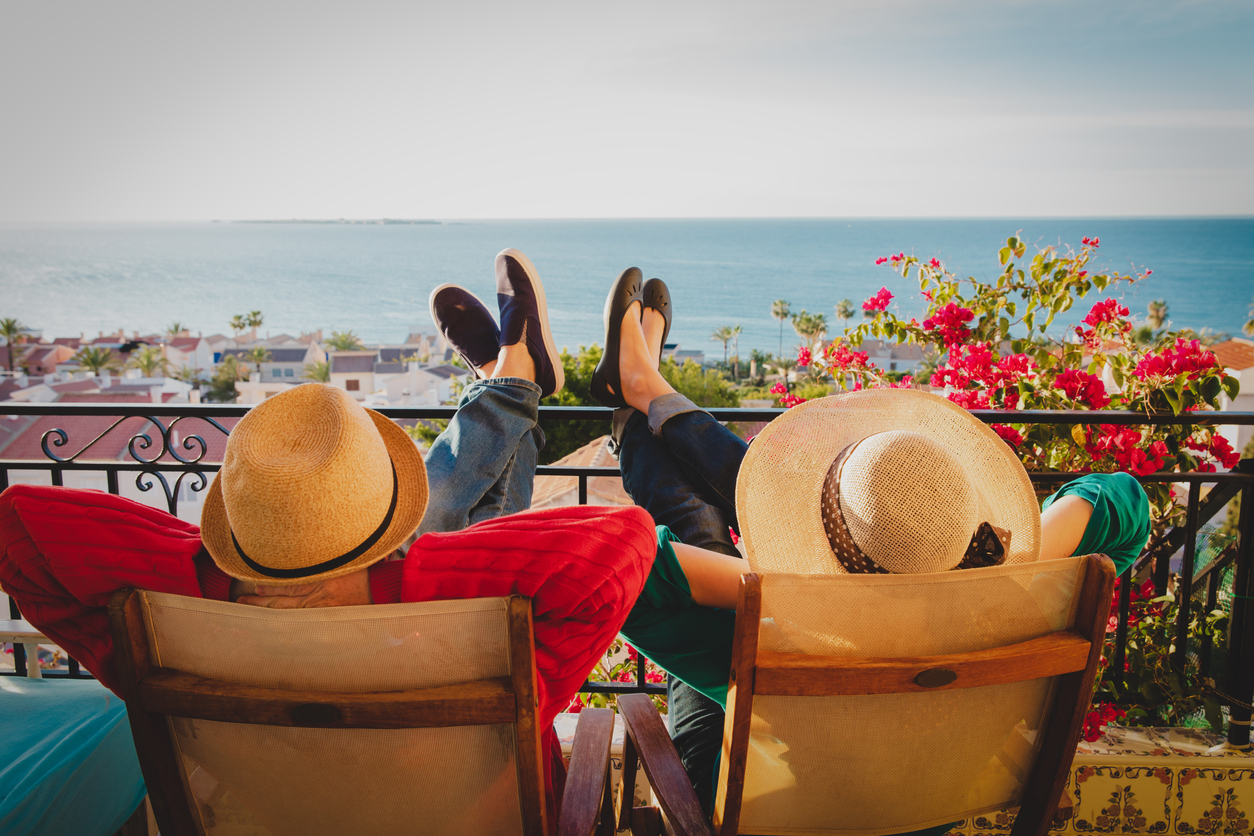 Happy couple relaxing on balcony terrace