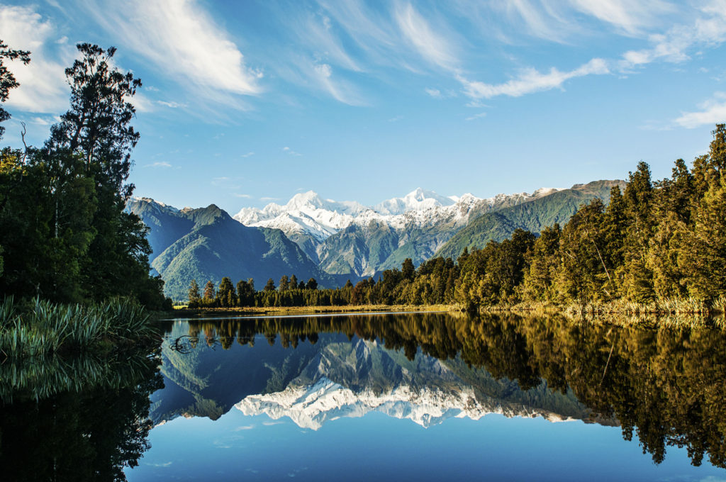 Reflections of Mount Cook and Mount Tasman in Lake Matheson, Fox Glacier New Zealand.