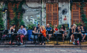 People sit at tables outside the restaurant at Rothschild Boulevard in Tel Aviv