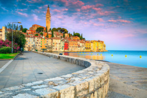 Rovinj harbor and old town with colorful buildings at sunrise