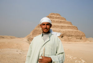 A traditional Egyptian tribesman stands near the Step Pyramid in Saqqara, just outside Cairo