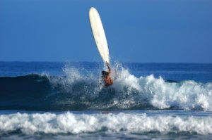 Surfer in Dominican Republic taking a hit on a big wave