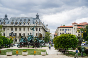 A Carriage with Clowns sculpture in front of the Bucharest National Theater