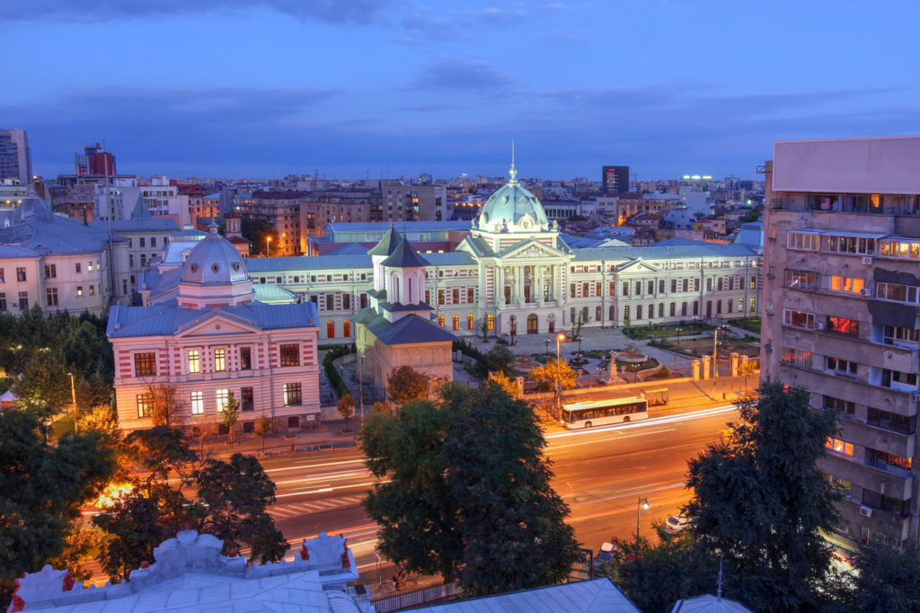 Aerial view over Bucharest skyline with a focus on the historic Coltea Hospital complex.