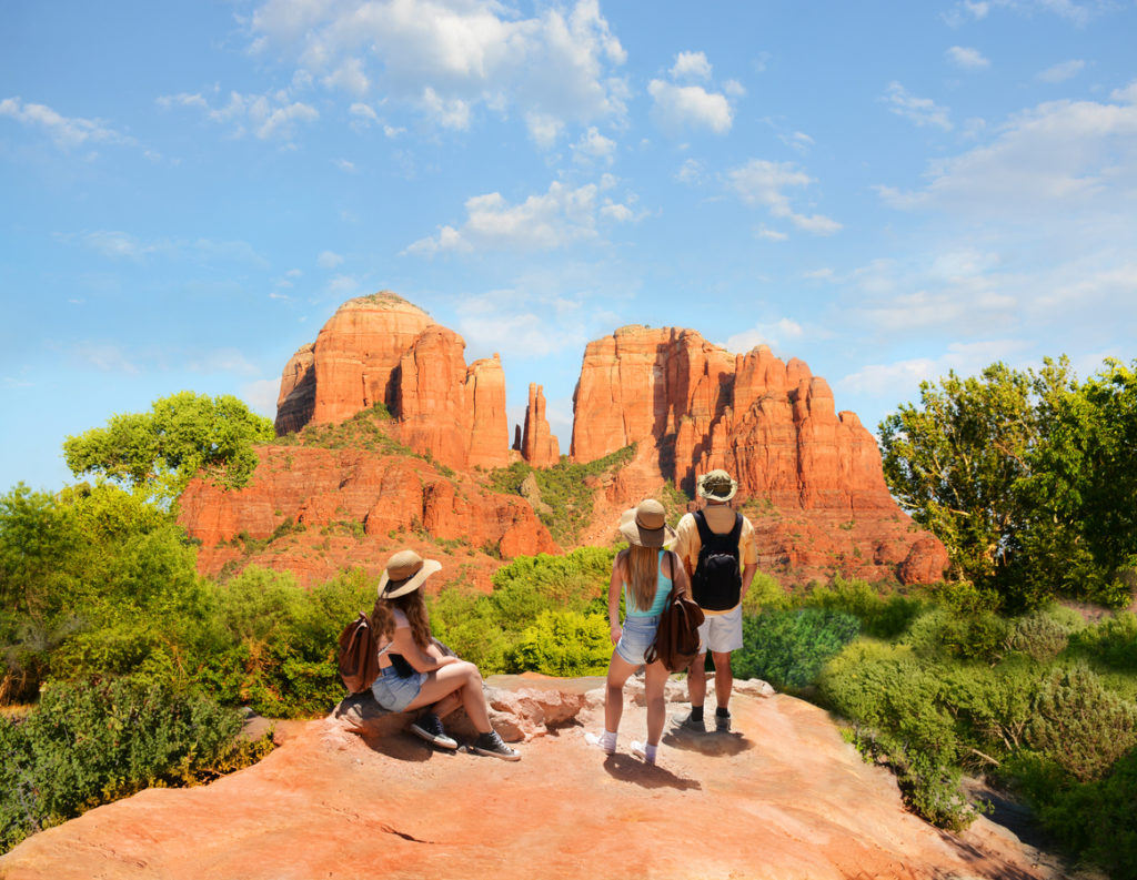 Family enjoying beautiful mountain view on summer hiking trip.