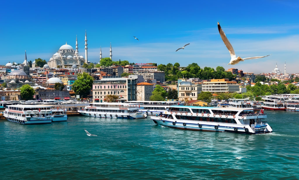 Touristic boats in Golden Horn bay of Istanbul and view on Suleymaniye mosque, Turkey