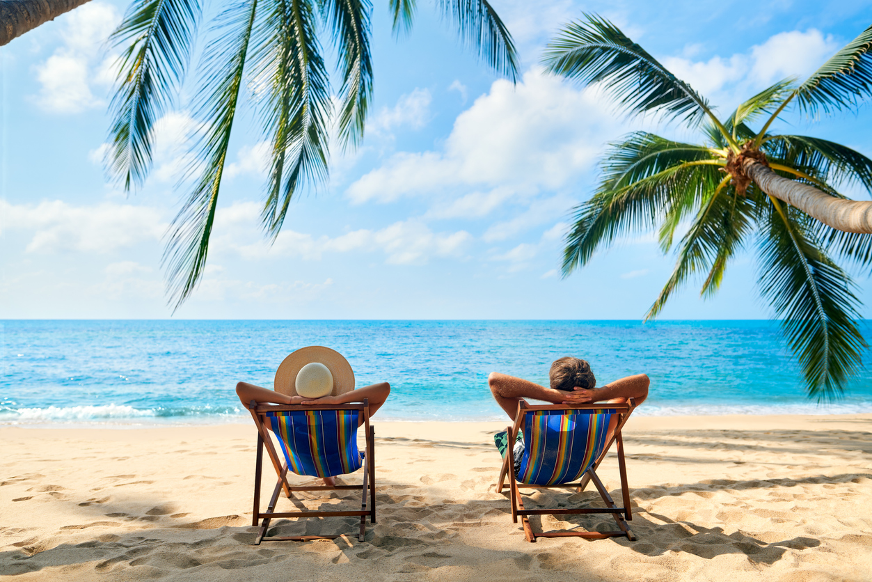 Couple relax on the beach enjoy the beautiful sea on the tropical island