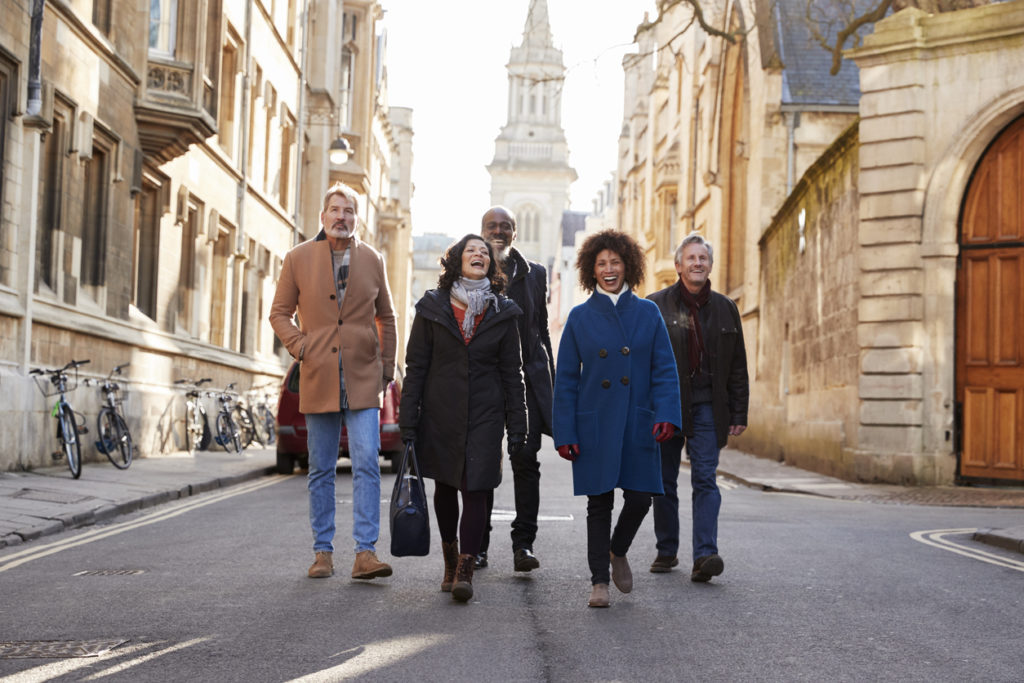 Friends Walking Through City