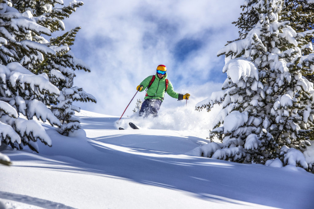 Skiing through trees in St Johann