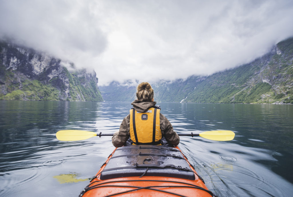 Kayaking in Geiranger fjord in Norway.