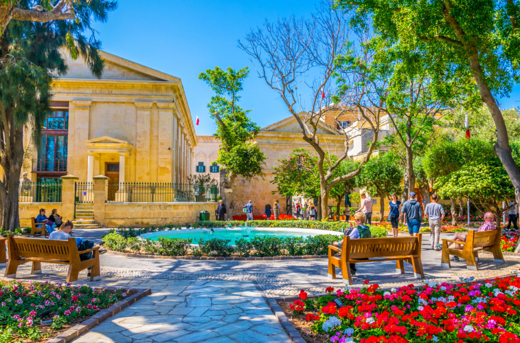 People are enjoying shade in the upper barrakka gardens in Valletta, Malta