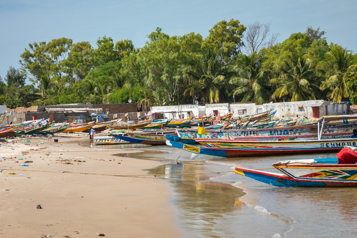 Traditional painted wooden fishing boat in Djiffer, Senegal. West Africa.