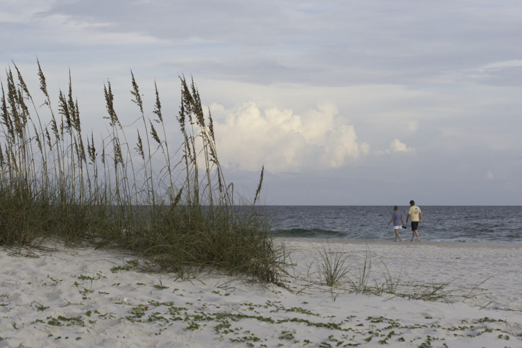Couple walking on the beach at Gulf Shores State Park