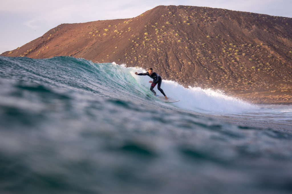 Surfer riding waves on the island of Fuerteventura