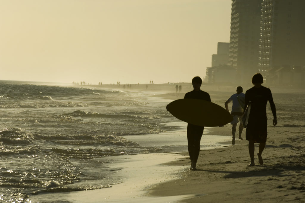 Surfers on the beach at Gulf Shores