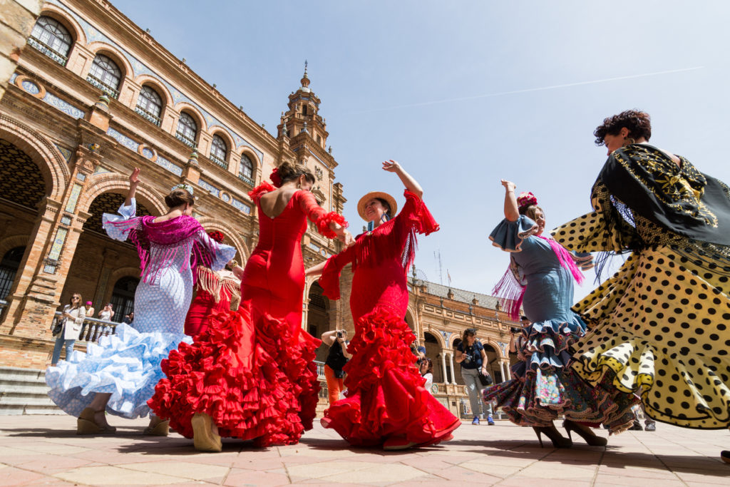 women dance flamenco on Plaza de Espana in Seville, Spain