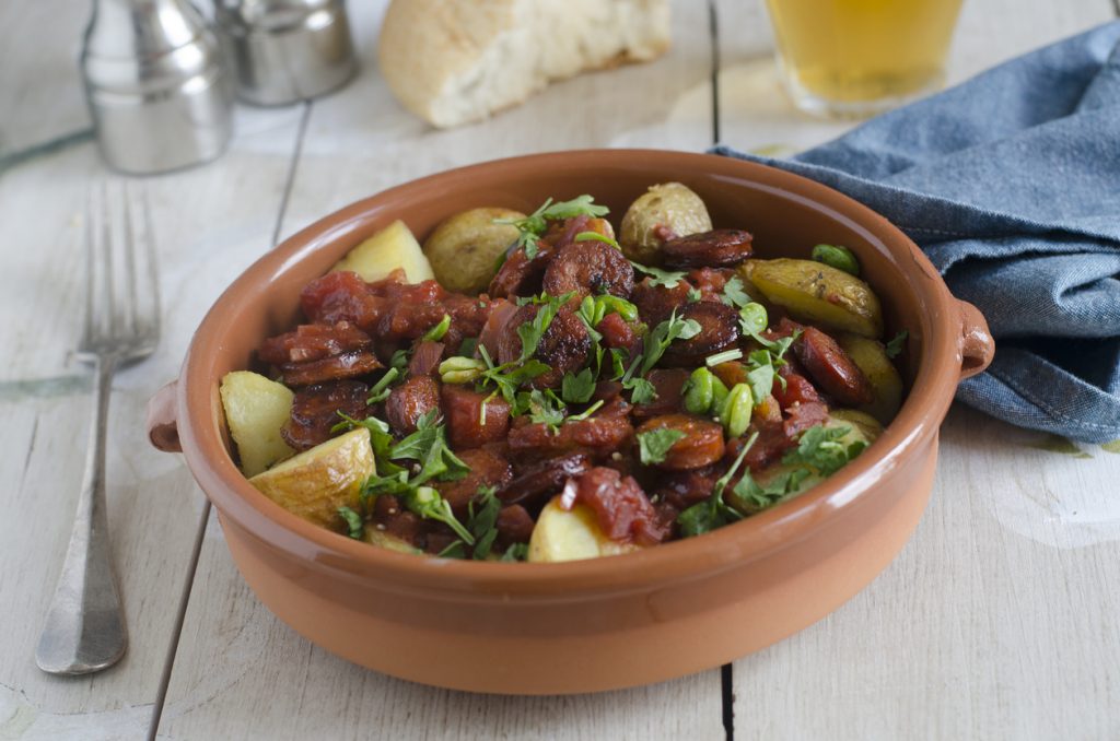 Traditional Spanish Patatas Bravas in a ceramic dish