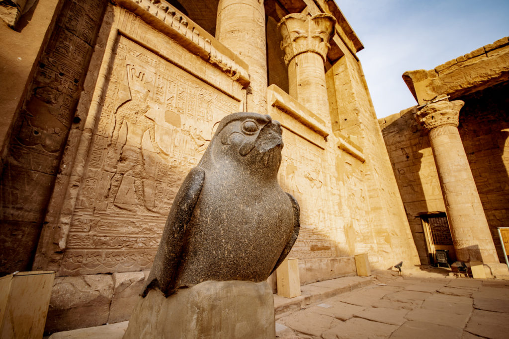 Sunset at Temple of Edfu with the statue of falcon God Horus