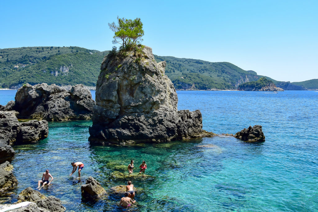 A Magestic rock with a tree in the bay in Corfu