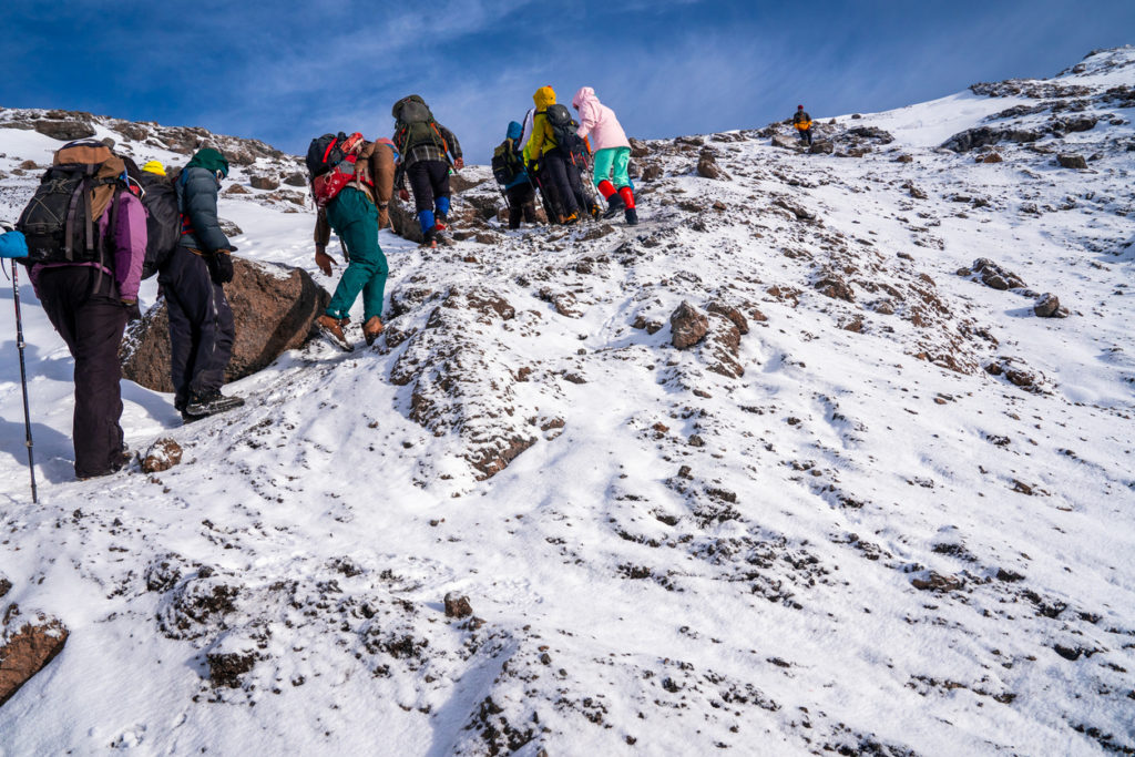 Group of trekkers hiking Kilimanjaro mountain