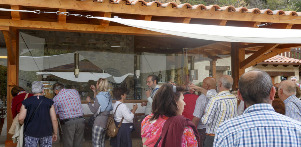 Tourists tasting the region Port Wine at the end of the river cruising on the Douro International Nature Park, in Miranda do Douro