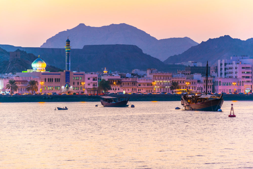 View of coastline of Muttrah district of Muscat during sunset, Oman