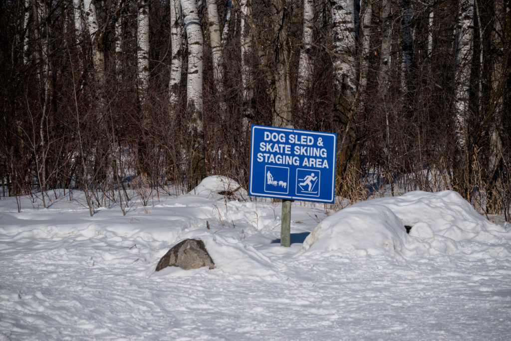 A sign that states that this is the dog and skate skiing staging area